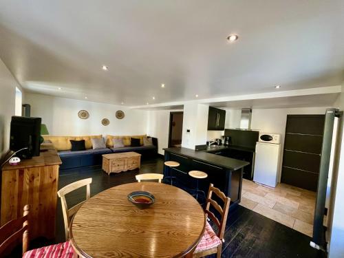 une cuisine et un salon avec une table et un canapé dans l'établissement Appartement 6 personnes, les 3 vallées, près des Thermes, à Brides-les-Bains