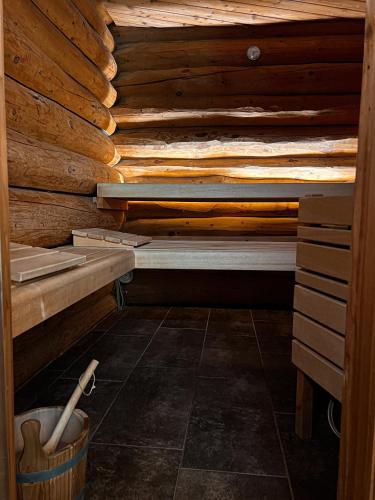 a sauna with wooden walls and a wooden floor at Guesthouse Smogavc in Zreče