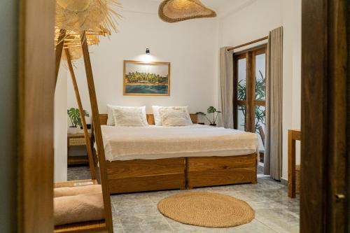 a bedroom with a bed and a mirror at Lucky's Surf Camp in Weligama
