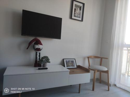 a living room with a tv on a wall at Bóbita Apartman in Zalakaros