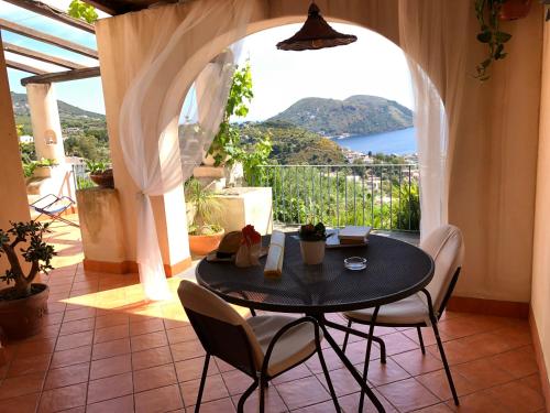 a table and chairs in a room with a view at Villa Hermes Case Vacanza in Lipari