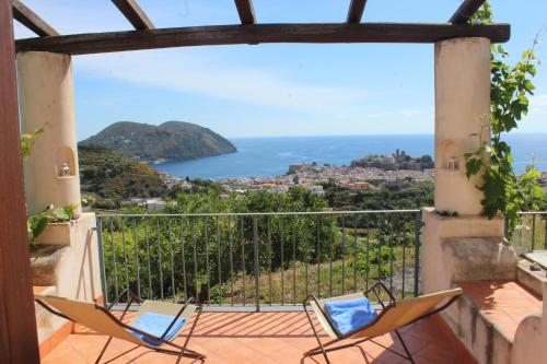 a balcony with chairs and a view of the ocean at Villa Hermes Case Vacanza in Lipari