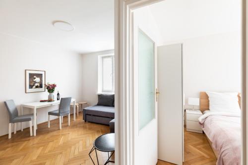 um quarto com uma cama, uma mesa e uma cadeira em P&O Apartments Gamerskiego em Varsóvia