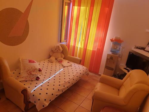 a childs bedroom with a crib and a teddy bear at DIANA Seaside Holiday in Olimp