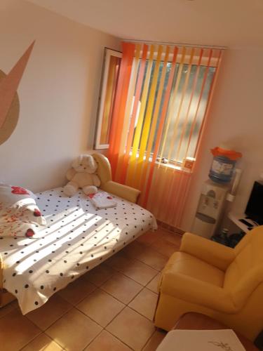 a childs bedroom with a bed and a teddy bear at DIANA Seaside Holiday in Olimp