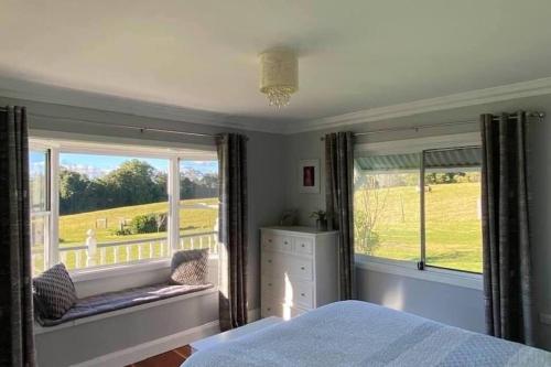 a bedroom with a bed and a window with a view at 100 acres of mountain paradise all to yourself in Berry
