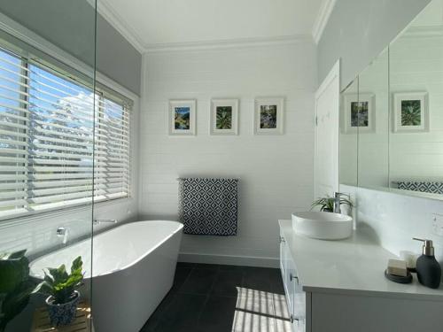 a white bathroom with a tub and a sink at 100 acres of mountain paradise all to yourself in Berry