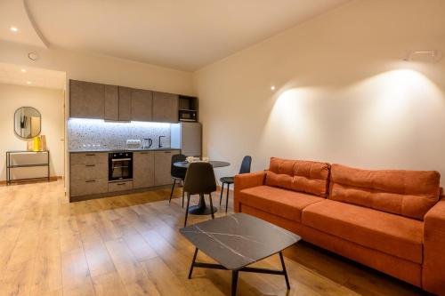 a living room with a couch and a table at Kastani Factory Apartments in Tartu