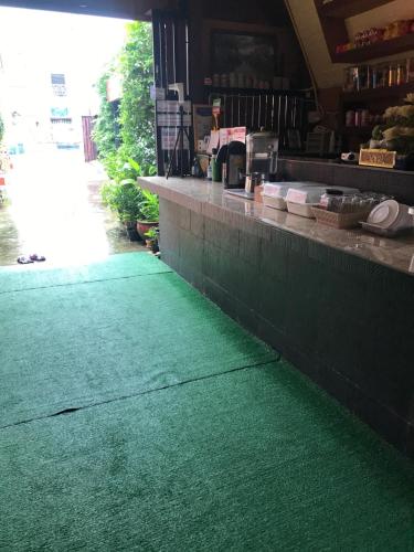 a green floor in the front of a restaurant at Baan Aomsin in Chiang Khan
