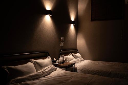 a hotel room with two beds and lights on the wall at リゾートイン西表島 in Iriomote