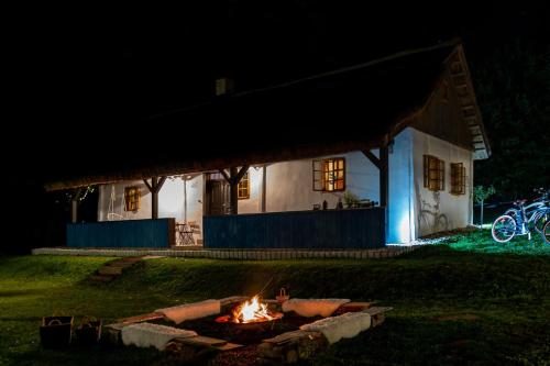 a fire pit in front of a house at night at GORIČKE IŽE in Križevci