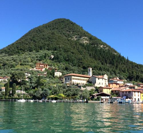 a town on a hill next to a body of water at Castello Oldofredi in Monte Isola