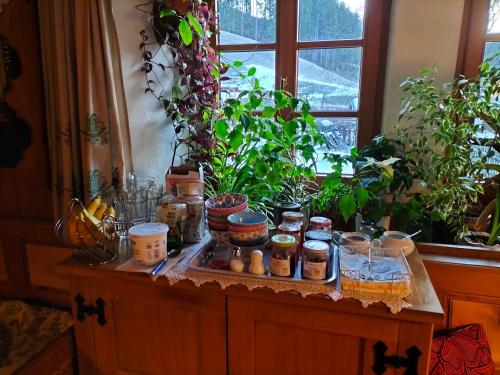 a table with jars and plants on top of it at Köstlhof, Familie Hassler in Oberdrauburg