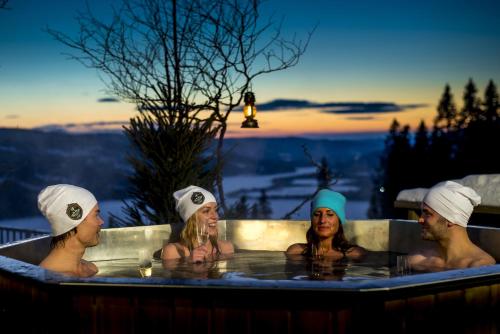 a group of people in a hot tub at Hotell Fjällgården Ski-In Ski-Out in Åre