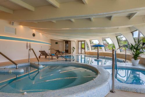a pool in a hotel with a large swimming pool at Playa Esperanza Resort Affiliated by Meliá in Playa de Muro