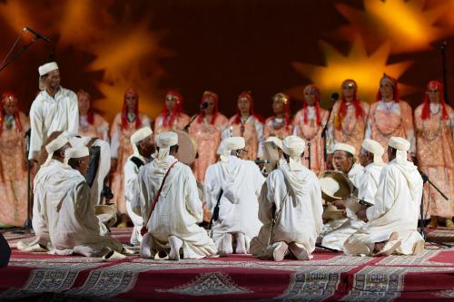 a group of people are sitting on a stage at Riad Parfums de OUARZAZATE in Ouarzazate