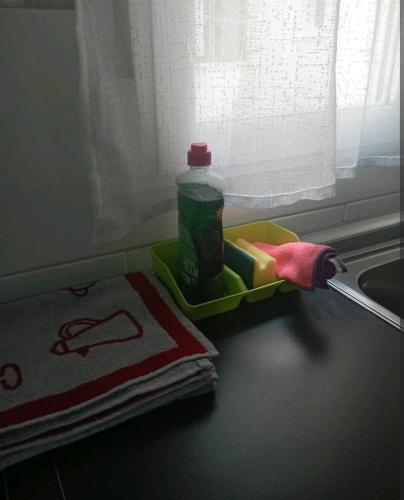 a toothbrush and a bottle on a counter next to a window at Apartamento parque sur de Hellín in Hellín