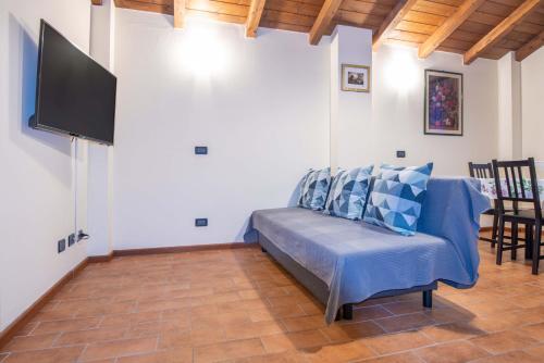 a living room with a couch and a flat screen tv at Il Falco in Castellarano