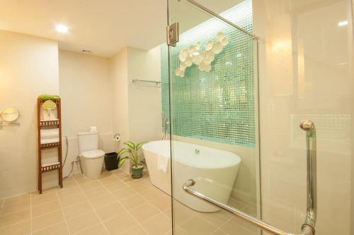 a bathroom with a shower and a tub and a toilet at THE PRIVILEGE FLOOR by Lotus Blanc in Siem Reap