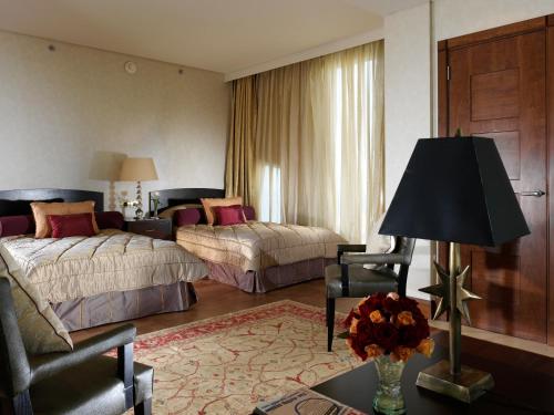 a hotel room with two beds and a couch at Phoenicia Residence in Beirut