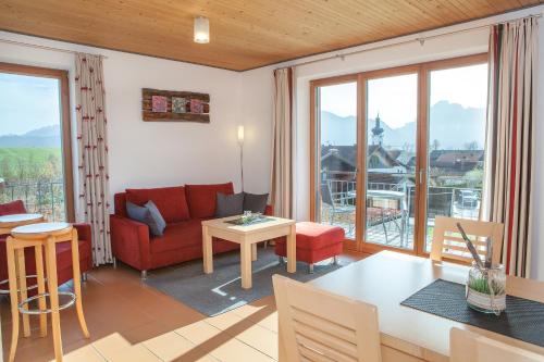 a living room with a red couch and a table at Haus Geier in Rieden