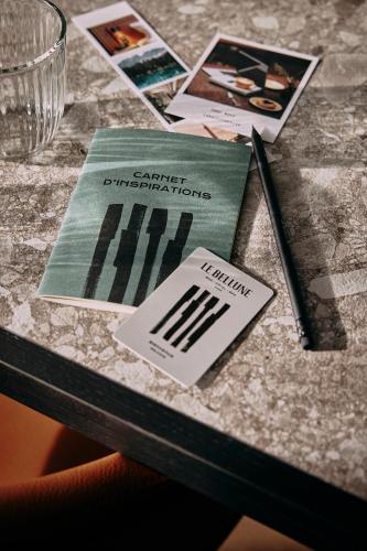 a table with cards and pamphlets on top of it at Le Bellune Paris in Paris