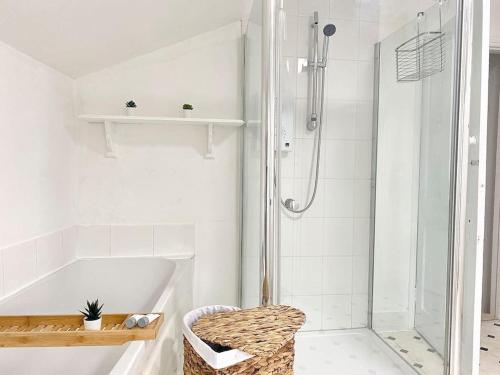 a white bathroom with a shower and a tub at Beautiful City Centre Home With Garden and Parking in Oxford
