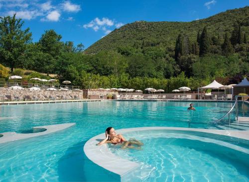un niño pequeño nadando en una piscina en B&B Cava Rossa, en Monsummano