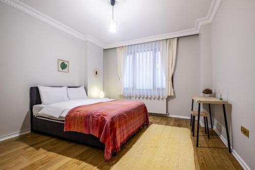 a bedroom with a bed and a window at Comfy in Istanbul