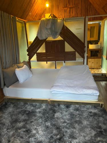 a bed in a room in a tent at Garden Homestay in Di Linh