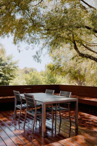 a table with two laptops on top of a deck at Losari Retreat in Margaret River Town
