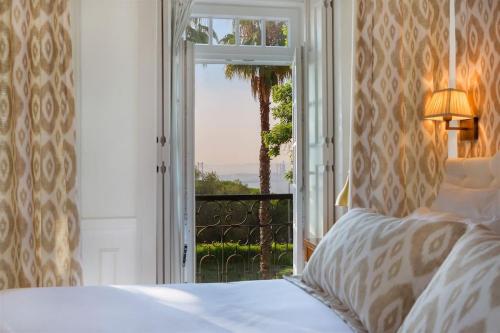 a bedroom with a bed and a window with a view at Casa do Presidente in Lisbon