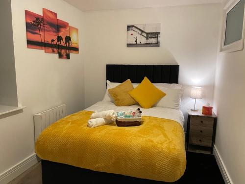 a bedroom with a bed with a tray of toys on it at Luxurious New 2 Bed Apartment in Burnley, Lancashire in Burnley