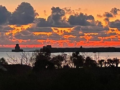 a view of a sunset with clouds in the sky at Bay View Villas in Methoni