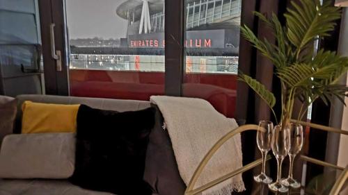 a living room with a couch and a window at Luxury Gem By Emirates Stadium - Ultimate Fan Experience in London