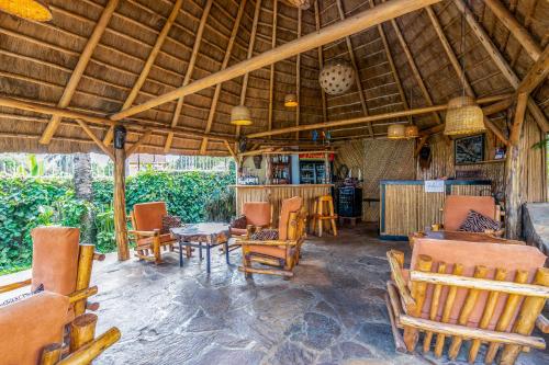 a living room with chairs and a table in a house at 2 Friends Beach Hotel in Entebbe