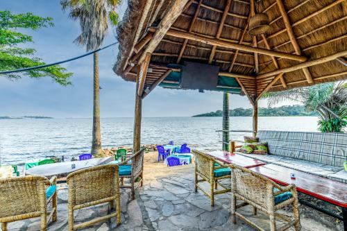 a restaurant with a view of the water at 2 Friends Beach Hotel in Entebbe