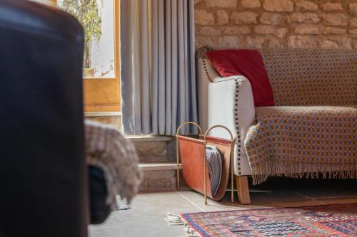 a living room with a couch and a chair at The Studio in Castle Bytham