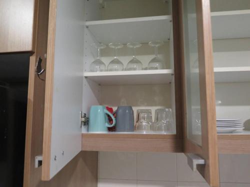 a cupboard with wine glasses and plates in it at 7A-Short-term rental allowed-2BRs Downtown Bangkok in Makkasan