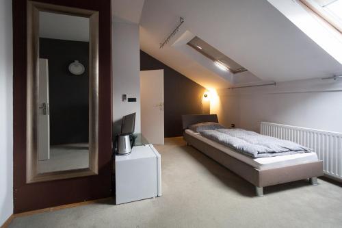 a bedroom with a bed and a large mirror at Centar W in Osijek