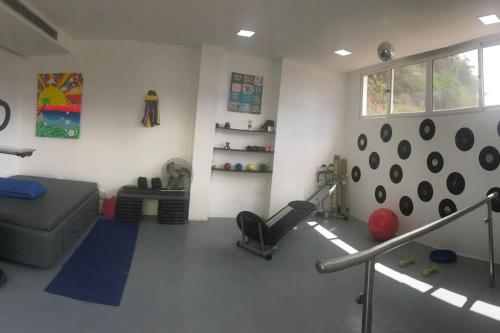 a room with a gym with a couch and a ball at Lomas del Encanto, villa en la montaña cerca del mar in La Asunción