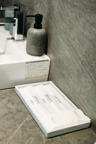 a bathroom with a soap dispenser on a counter at Blinghouse in Hualien City