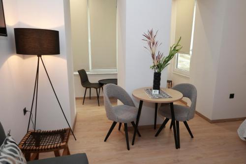 a living room with a table and chairs at Platanos house in Plomarion