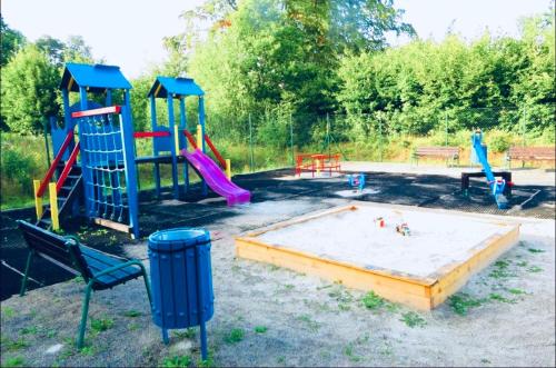 a playground with a slide and a play structure at Apartament Dream Apart II in Szklarska Poręba