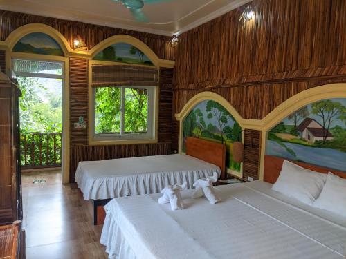 two beds in a room with two teddy bears on them at Ninh Binh Greenland Homestay in Ninh Binh
