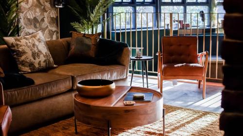 a living room with a couch and a coffee table at The Funky Monk in Durham