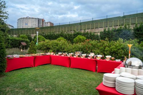 a group of people sitting on a red bench at Ibis Istanbul Tuzla Hotel in Tuzla