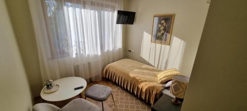 a small room with a bed and a table at Irbēni in Brivkalni