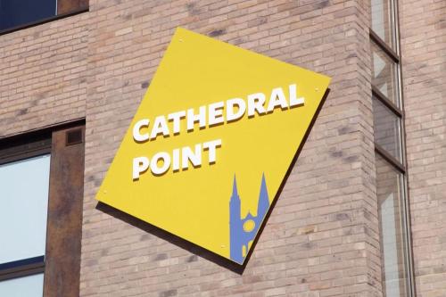 a yellow sign on the side of a brick building at For Students Only Cathedral Point in Winchester in Winchester