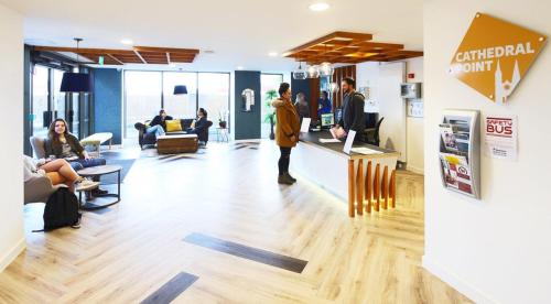 un groupe de personnes dans un bureau avec des personnes assises dans l'établissement For Students Only Ensuite Bedrooms with Shared Kitchen at Cathedral Point in Winchester, à Winchester